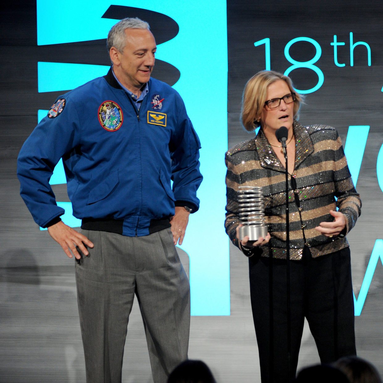 Astronauts Mike Massimino and Dr. Kathryn D. Sullivan speak onstage at the 18th Annual Webby Awards.