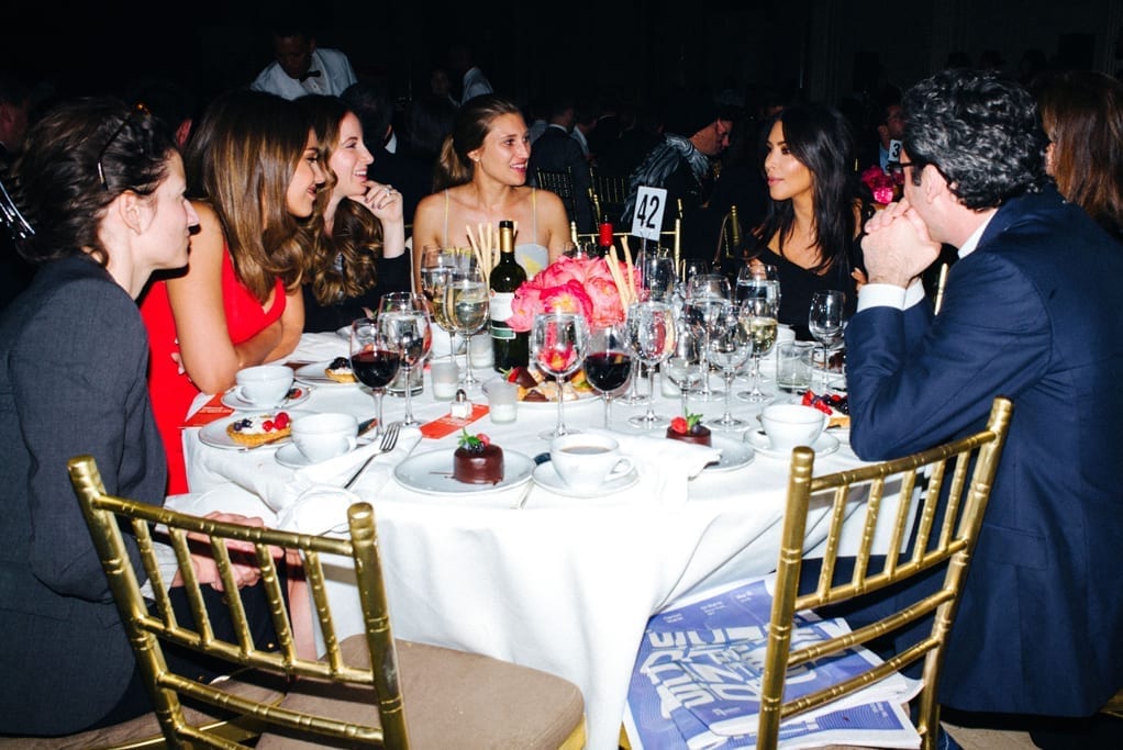 Kim Kardashian West, Jessica Alba & Neil Blumenthal chatting at their table at the 20th Webby Awards